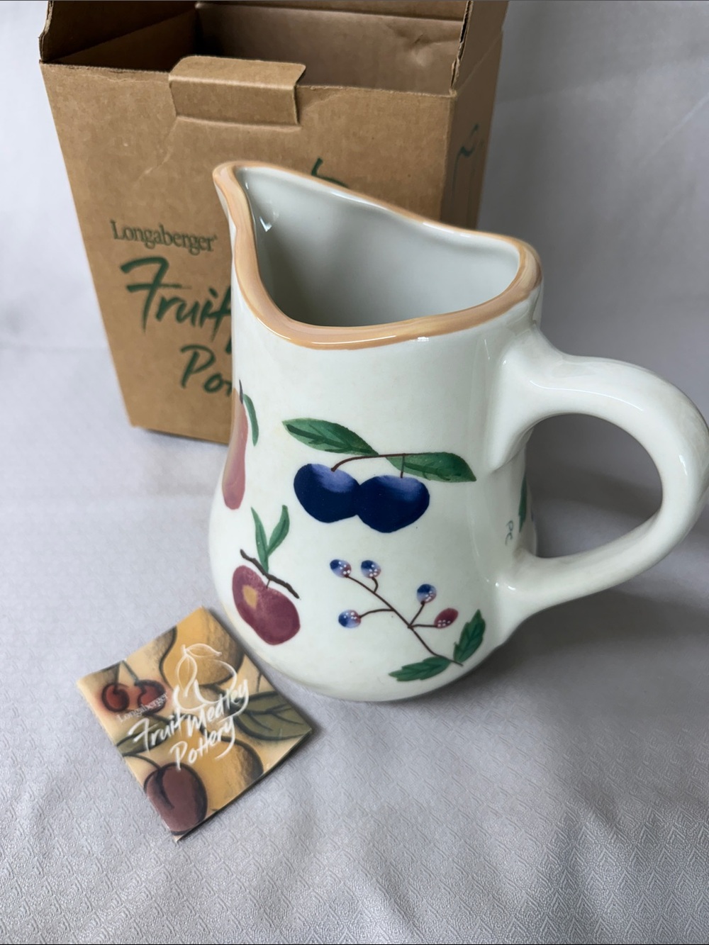 Longaberger White Ceramic Pitcher with Peach Rim and Multicolor Fruit Motif